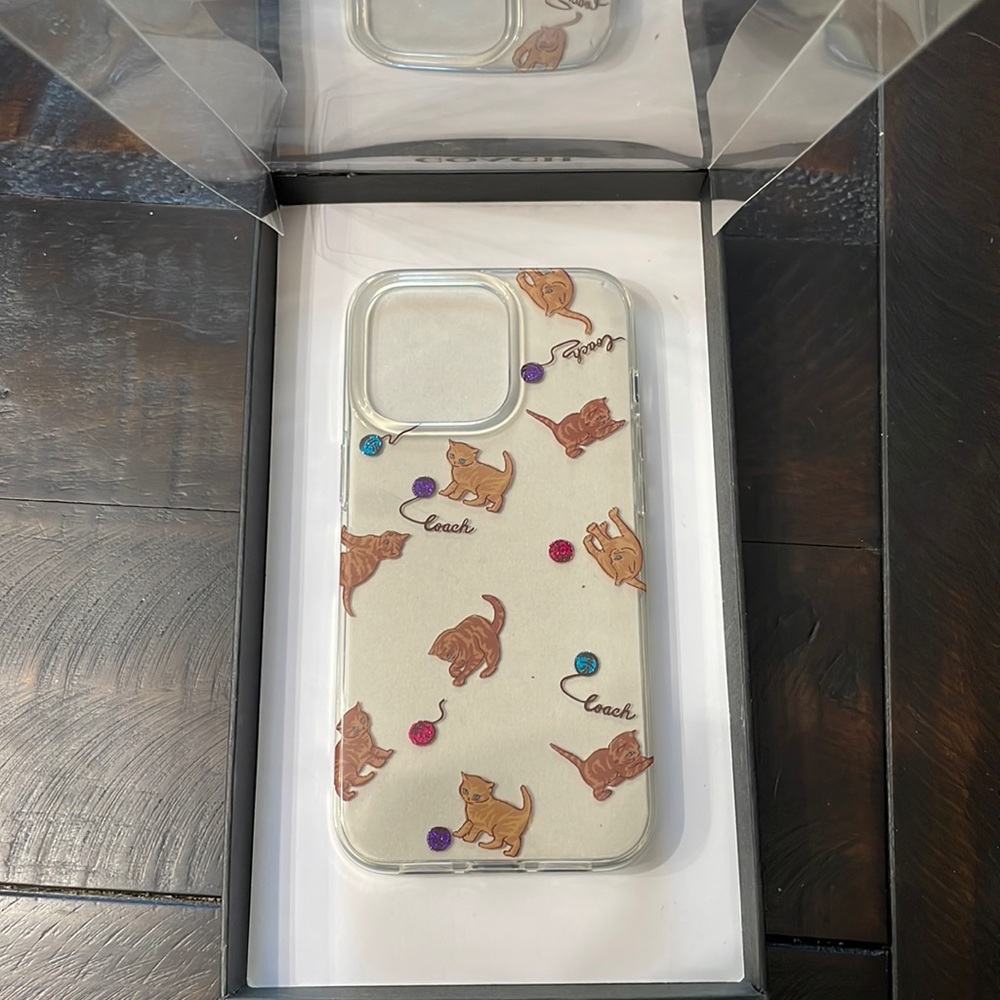 Coach phone case. Brand new. Fits the IPhone 13 Pro.